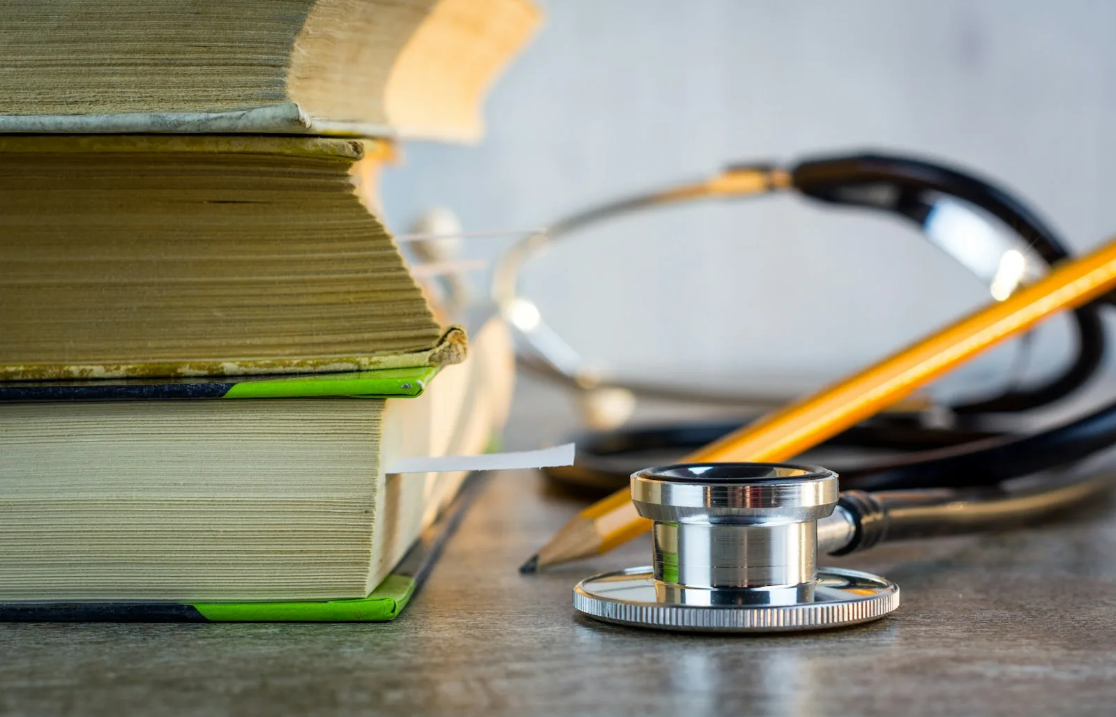 Medical books and stethoscope on a study desk